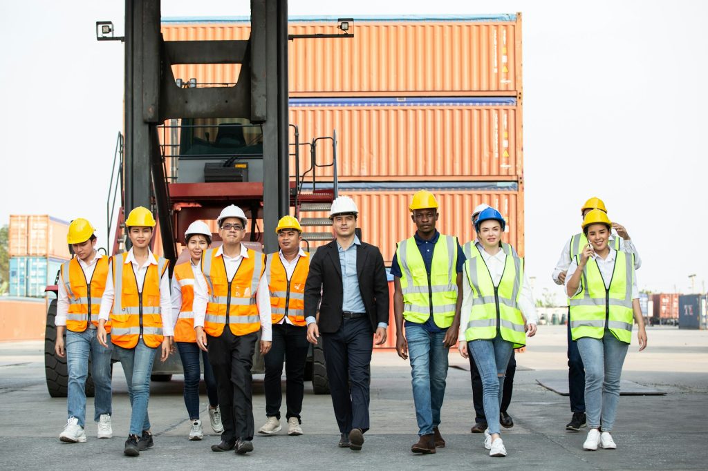 Corporate logistic team walking together at container warehouse